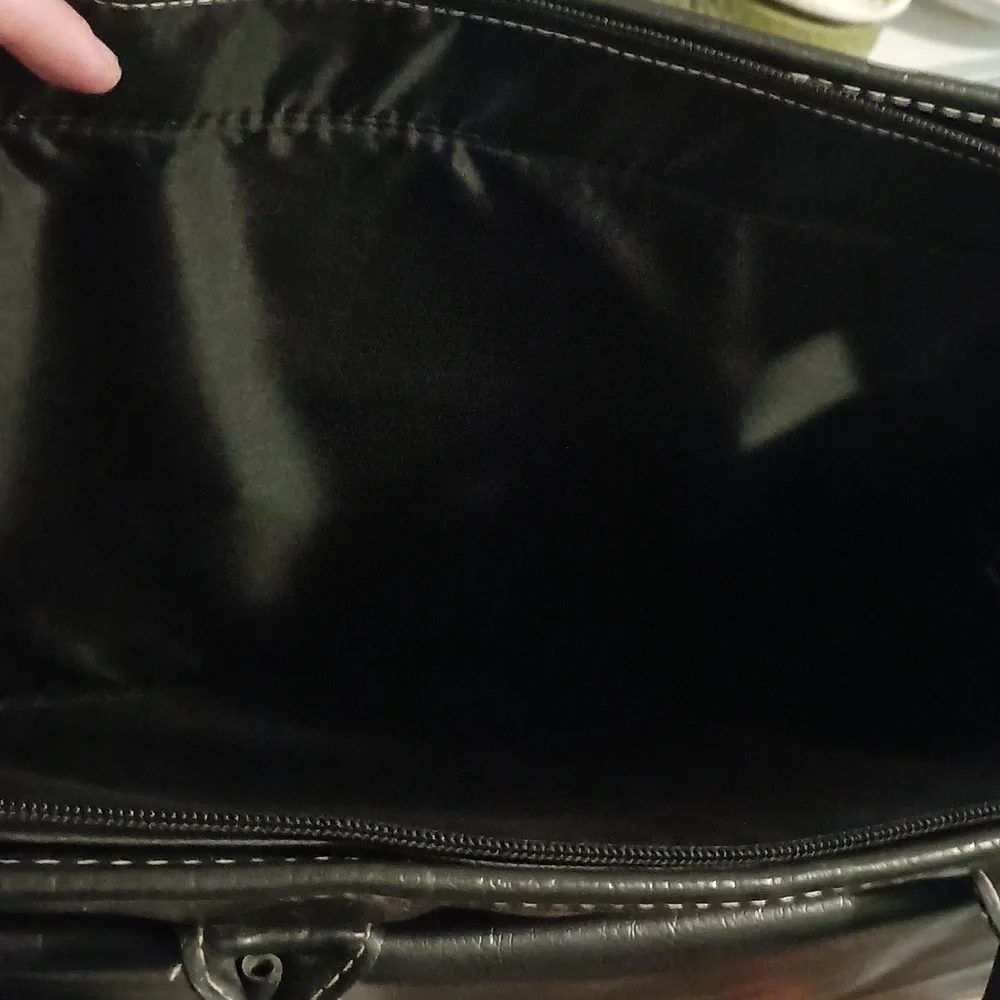 Global New Beginnings Leather laptop bag with pockets. Black bag includes strap